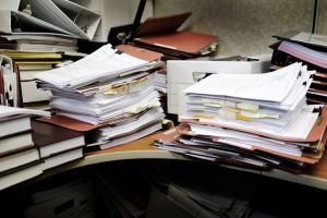 Detail,Of,A,Messy,Desk,With,Books,Binders,Files,And
