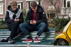 Amsterdam,,Netherlands,-,October,26:,Two,Teenagers,Sit,On,The
